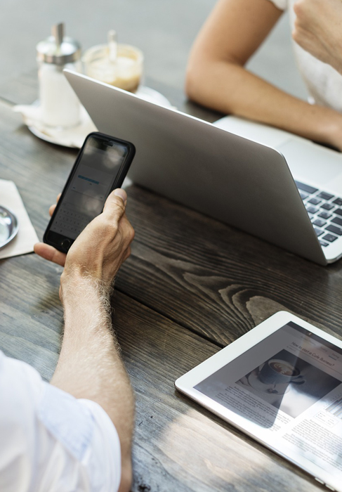 man and woman with iPhone, iPad and Apple Mac Book Pro
